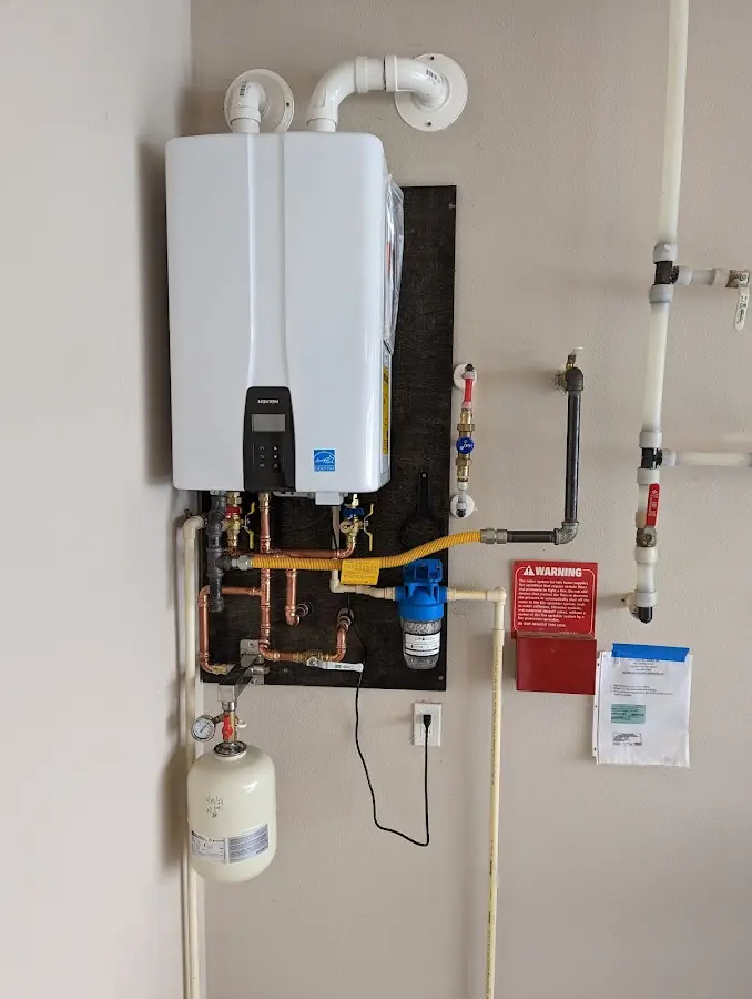 Professional plumber installing copper piping in a Rogersville home